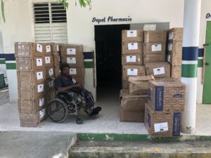 Junior, St. Joseph Clinic administrator, picking up supplies sent by Medial Missionaries for the Clinic