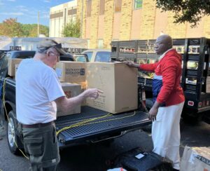 Dr Chienku and Dr Irwin loading packages to send to Cameroon.